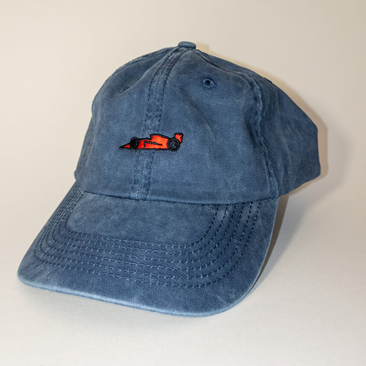 Red race car logo on washed blue hat